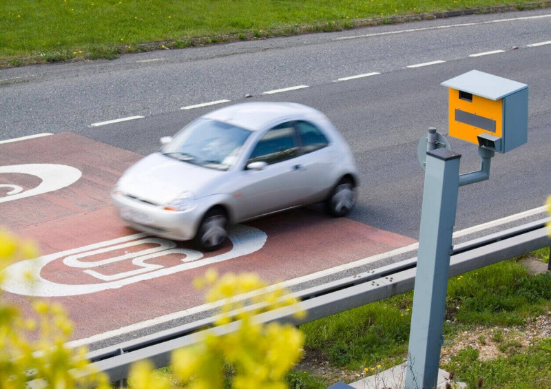 A car speeding past a speed camera