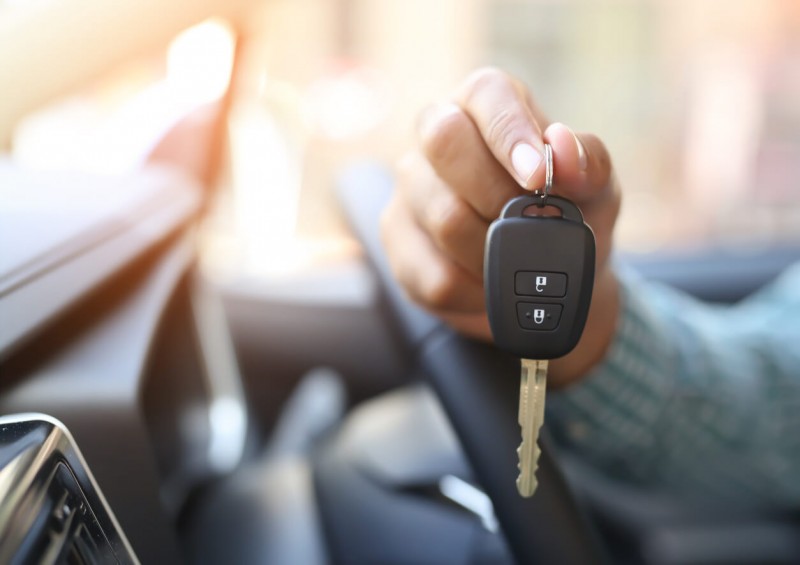 A close up of person s hand holding a car key
