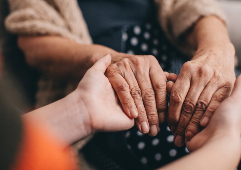 A close up of two people holding hands