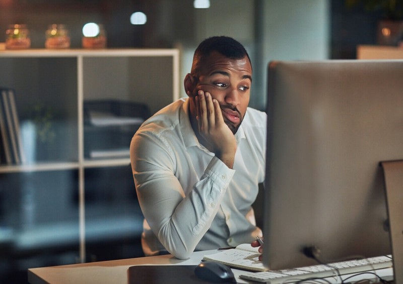 A customer looking at his computer and seeming confused