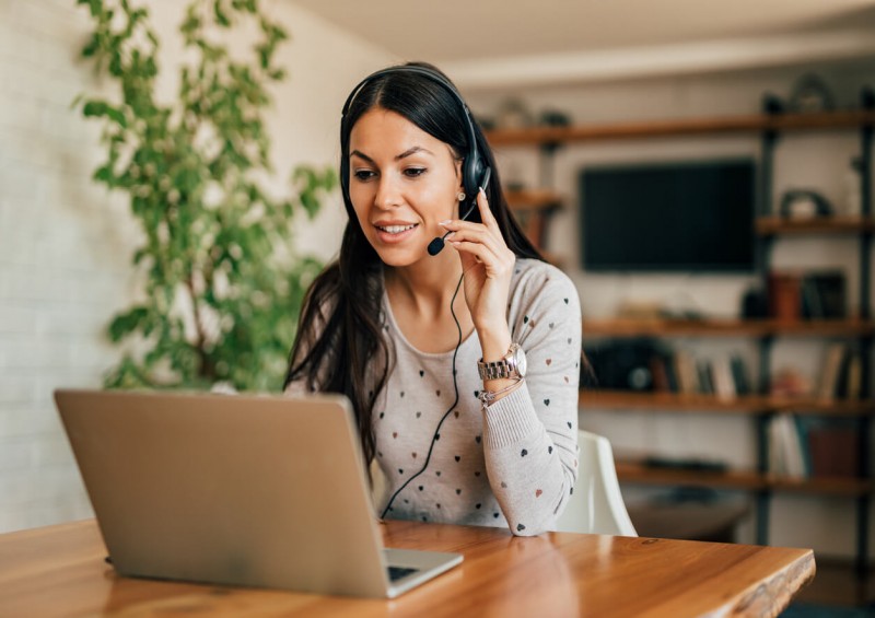 A happy female advisor on the phone to a customer