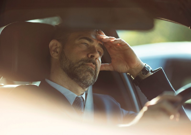 A male driver looking worried