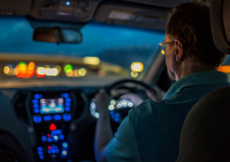 A man driving his car at night