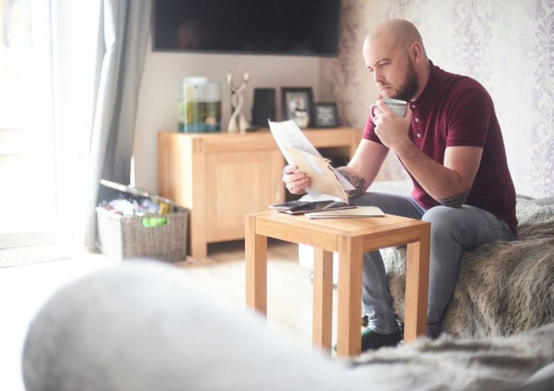 A man looking at his bills