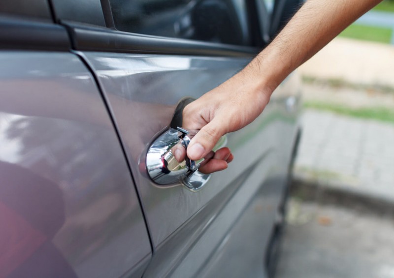 A man opening his car door