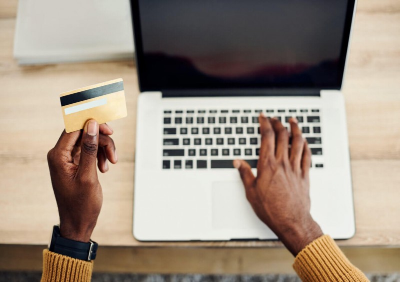 A man using his laptop to make credit card purchases
