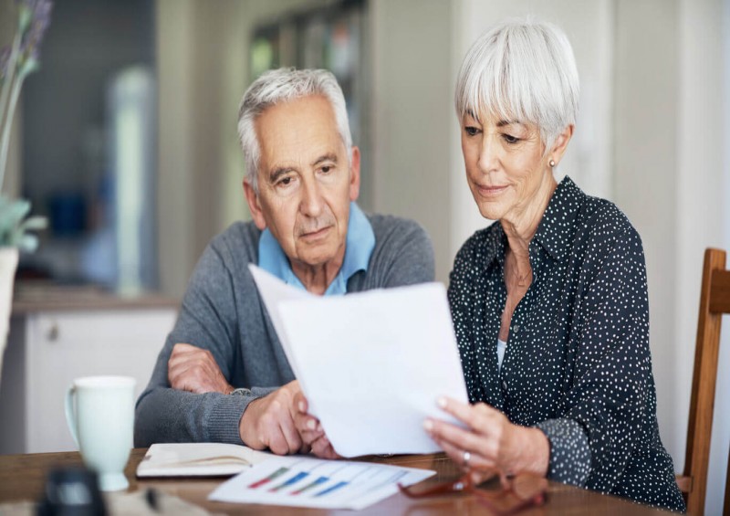 A mature couple looking at documents
