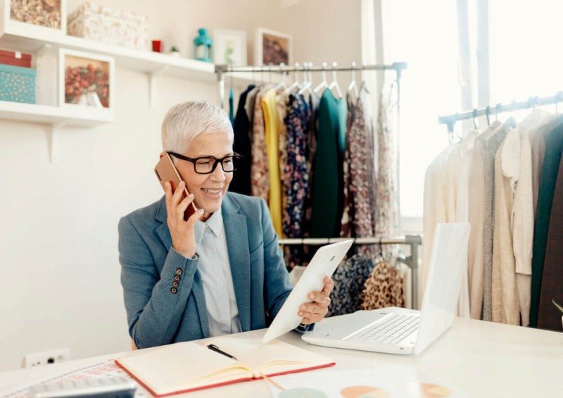 A mature self employed woman talking on the phone