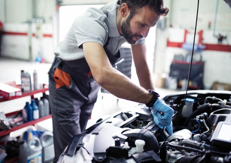 A mechanic assessing a car s engine