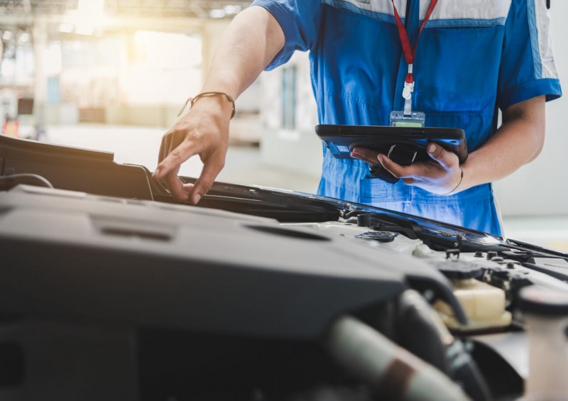 A mechanic looking at a car s engine