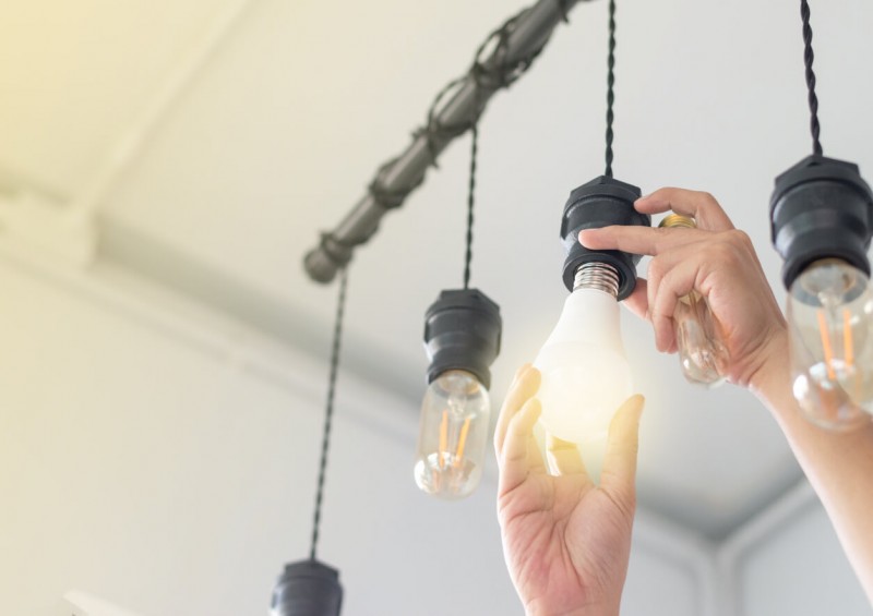 A person changing a light bulb