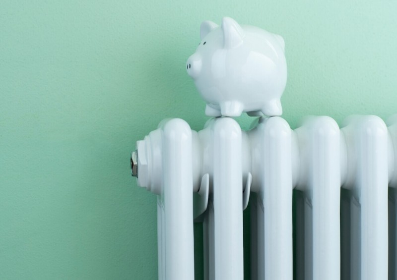 A piggy bank on top of a radiator