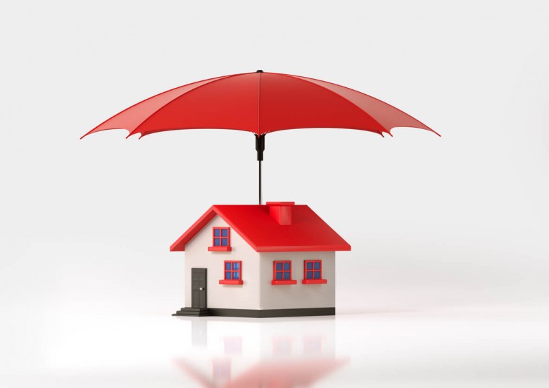 A toy house with umbrella attached to the top
