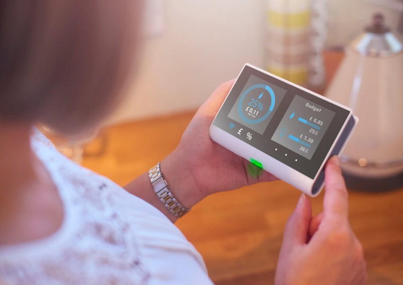 A woman looking at her energy usage on the in home display