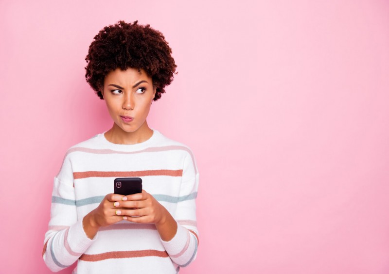 A woman on her mobile phone looking unsure