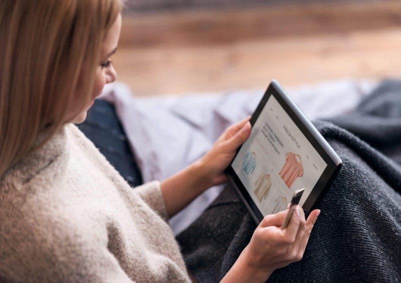 A woman shopping on her ipad with credit card