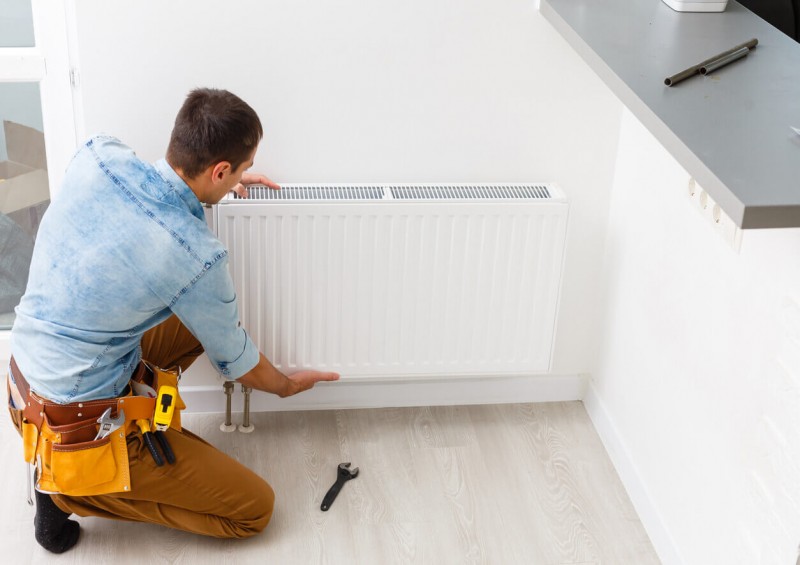 A worker fixing a radiator