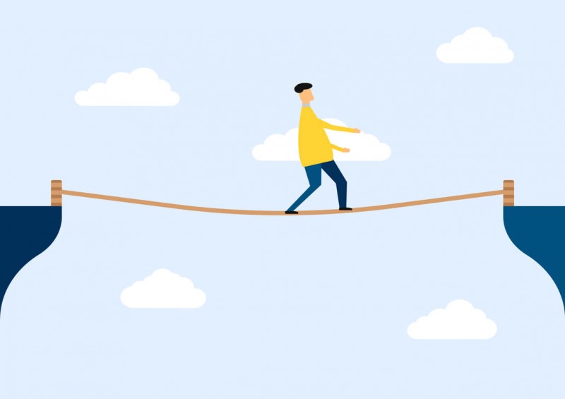An illustration of a person walking across a rope