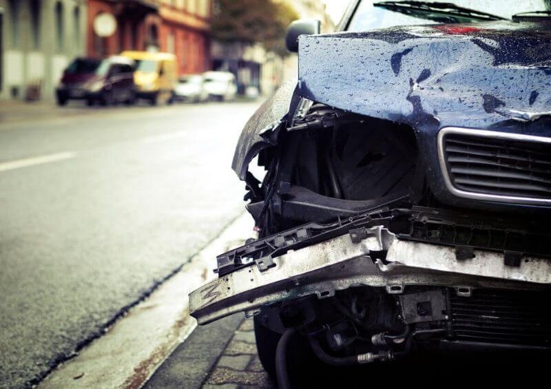 Black car crashed and written off