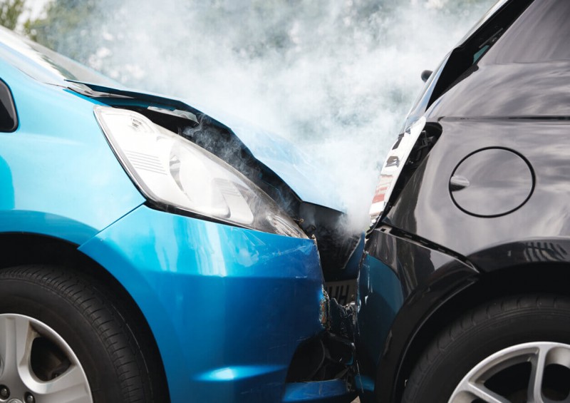 Blue car crashed into black car