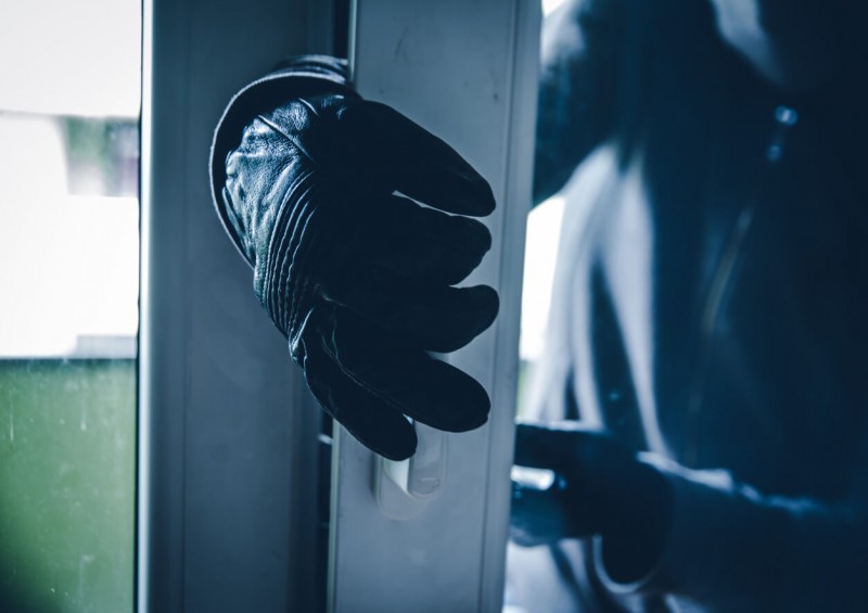 Burglar entering home with door open