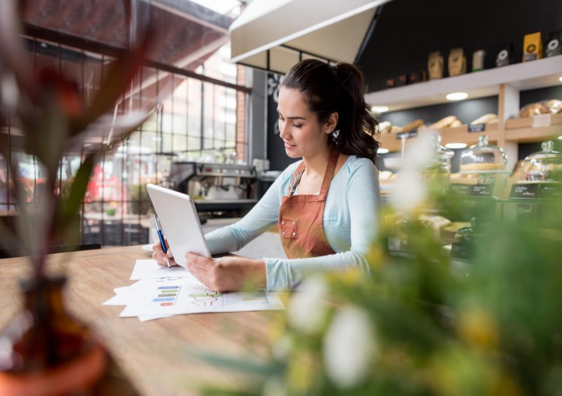 Business woman looking at documents and tablet