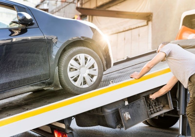 Car being loaded on recovery vehicle