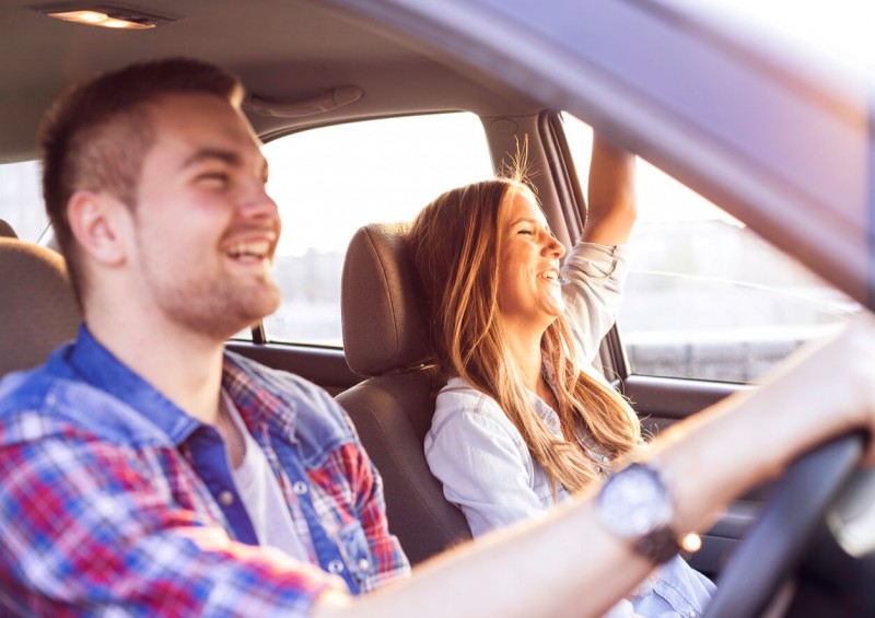 Couple happily driving a car
