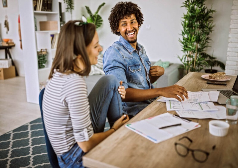 Couple smiling checking their debt letters