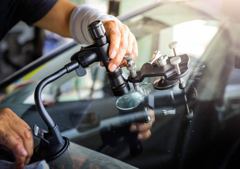 Cracked windscreen being repaired
