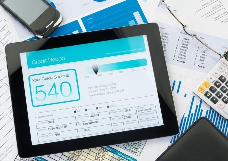 Credit score on tablet around documents