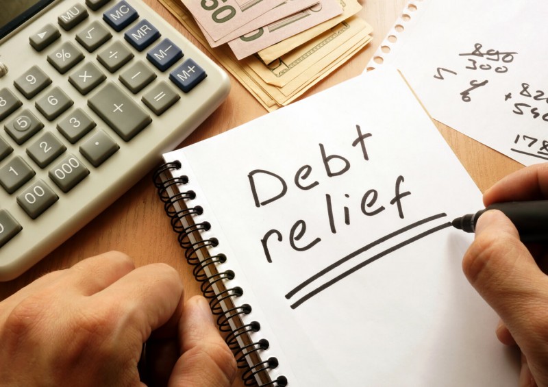 debt relief written on a notebook with marker