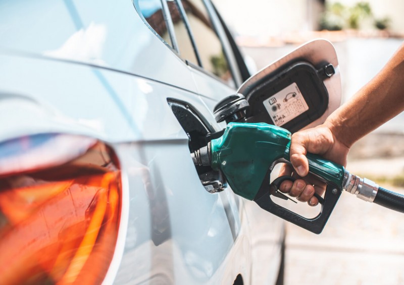 Driver putting petrol into his car