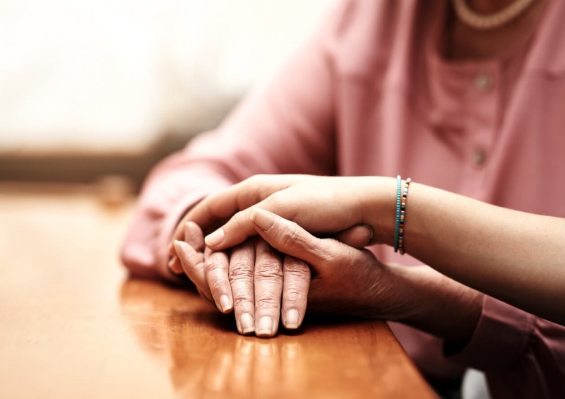Family holding hands after a death