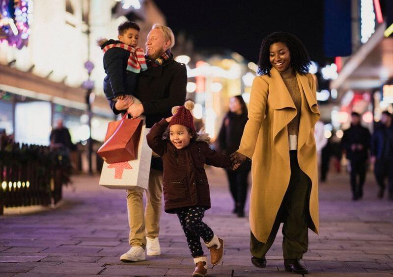 Family of four shopping at Christmas time