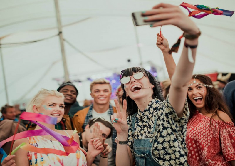 Friends taking a selfie at music festival
