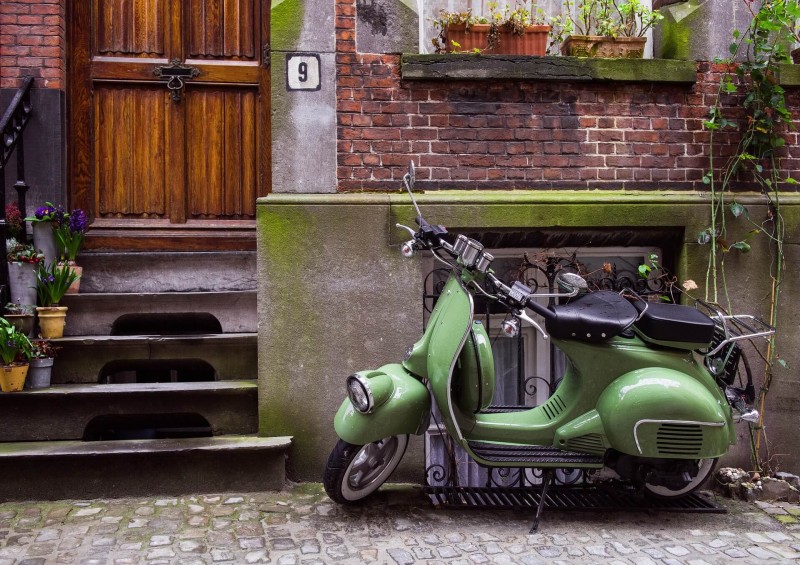 green moped outside hosue