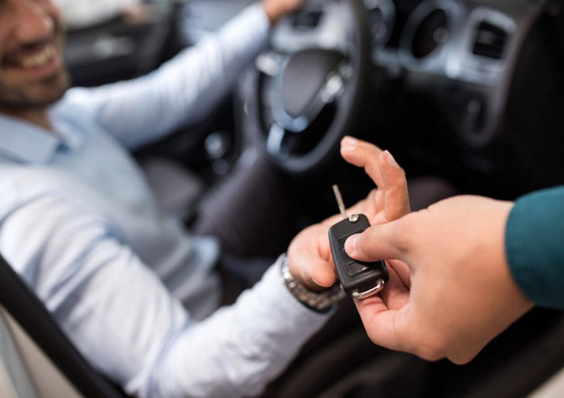 Handing over new car keys to customer