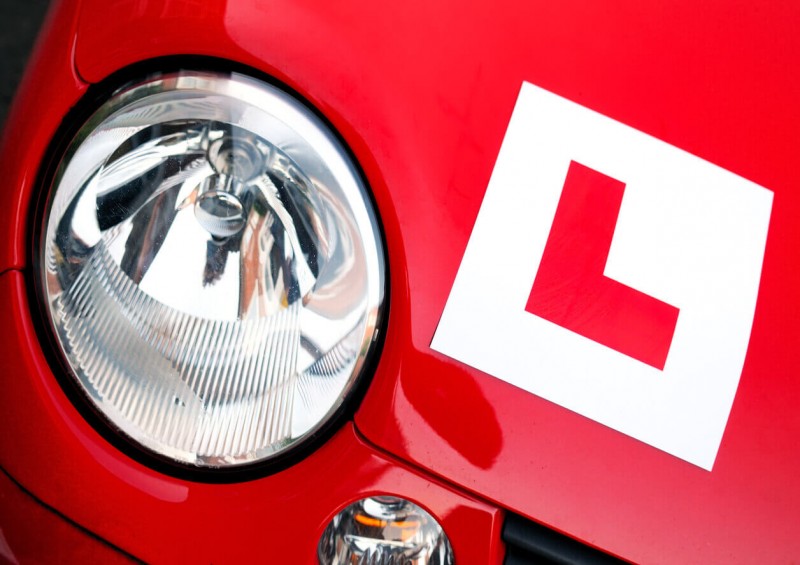 Learner driver plate on red car