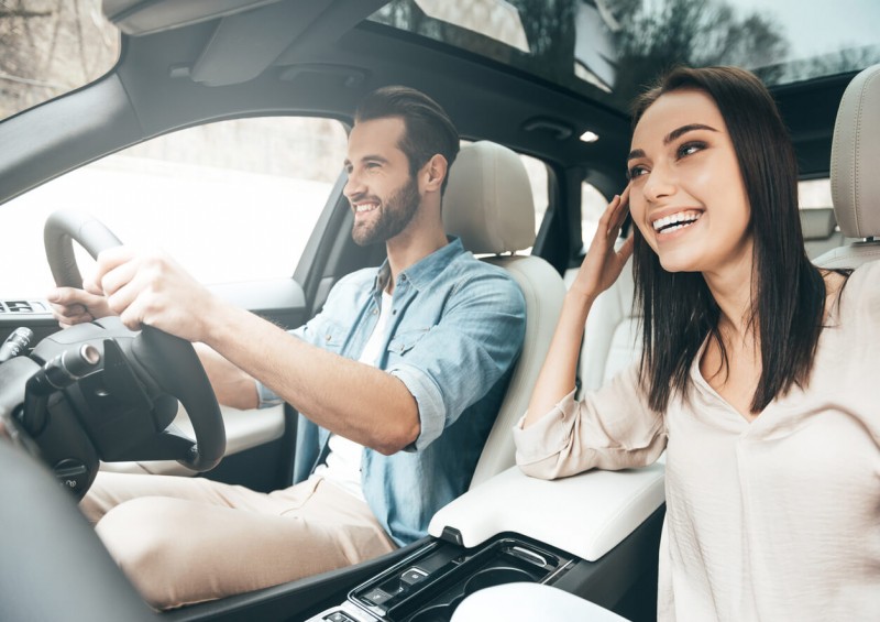 man and woman smiling in car