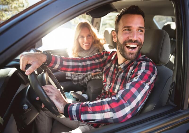 Man driving with woman passenger