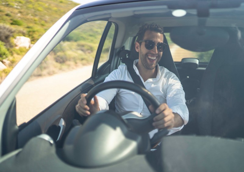 Man happily driving a car
