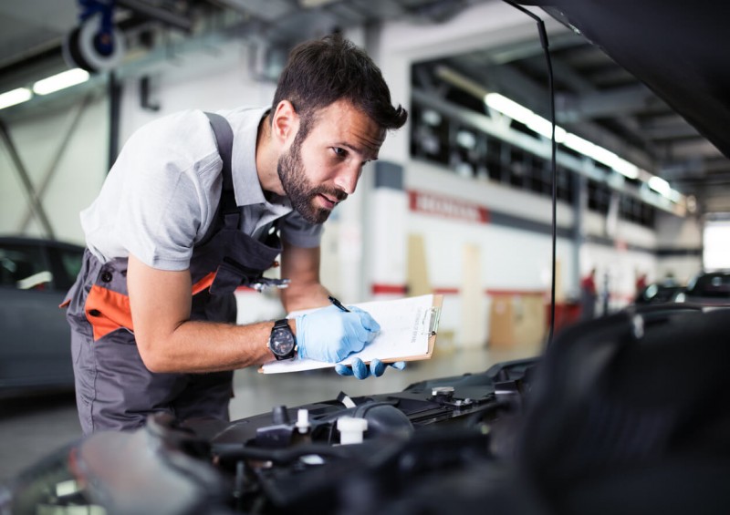 Man MOT testing a car at a garage