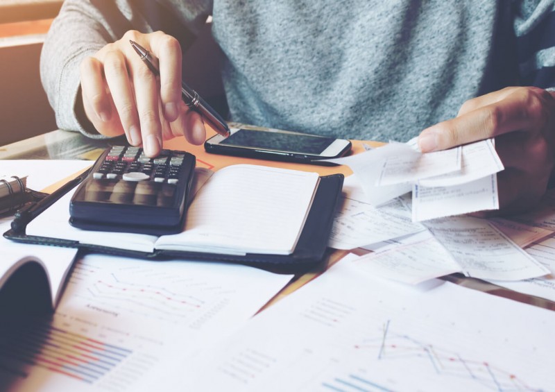 man with calculator and receipt