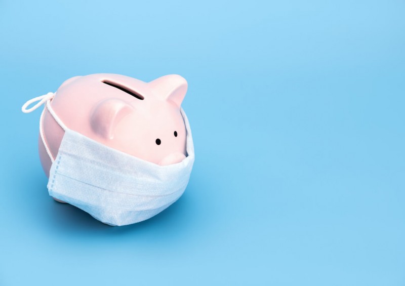 Money piggy bank with covid mask on