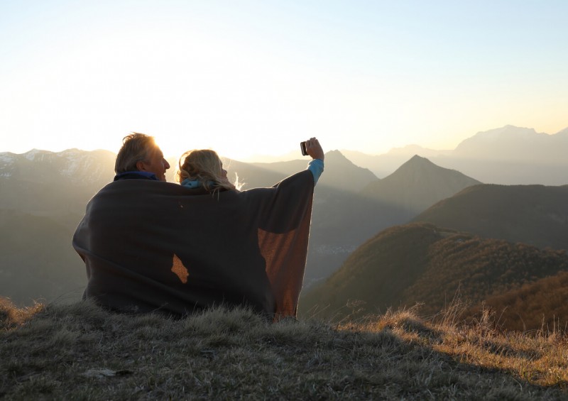 Older couple having a selfie at the top of a mountain