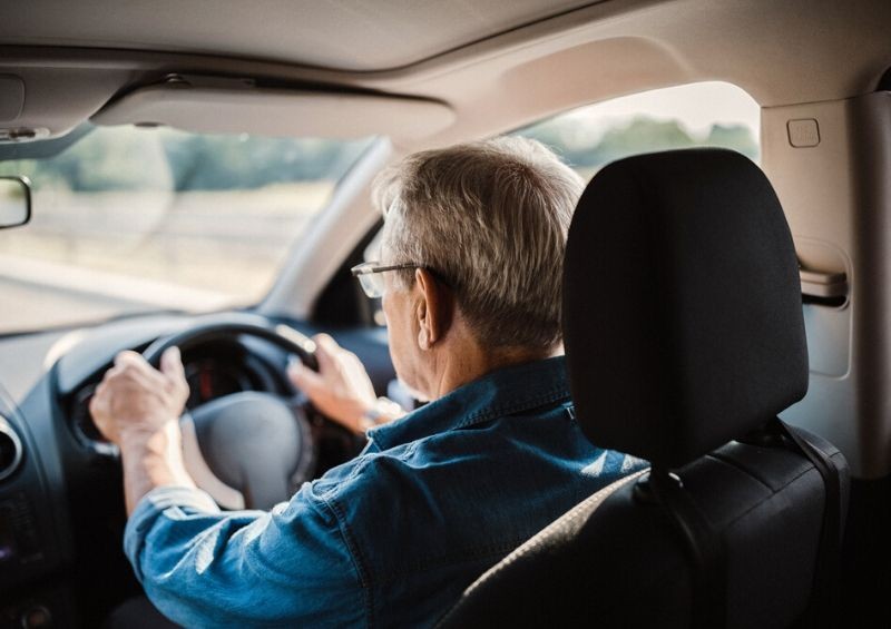 Older man driving car