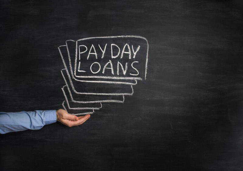 Payday loans written on white board