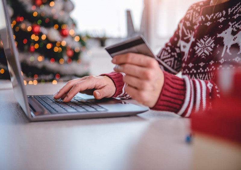 Person Christmas shopping with credit card