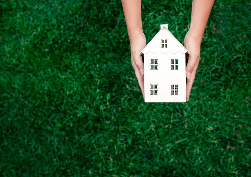 Person holding a cut out house
